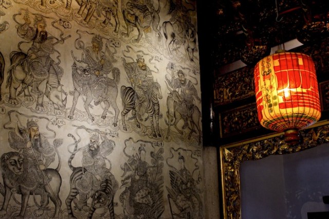 Interior of the Khoo Kongsi temple, every inch festooned with drawings and carvings of Chinese deities, heroes and symbols of good luck.