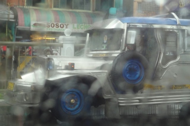 Apparition of a jeepney through the heavy rain.  View from my taxi along Roxas Boulevard.