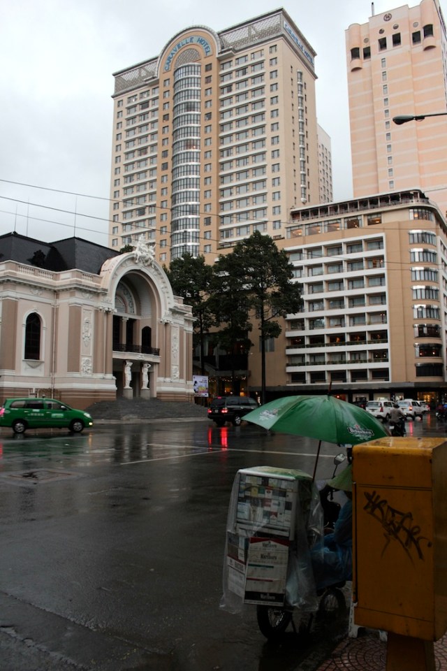 Finally, another view of the Opera House on a rainy evening. Looming over it is the last famous hotel on Rue Catinat – the Caravelle (1959), housing numerous foreign embassies and the offices of the New York Times and the Washington Post during the War. The original building sits to the right of the high-rise tower.  