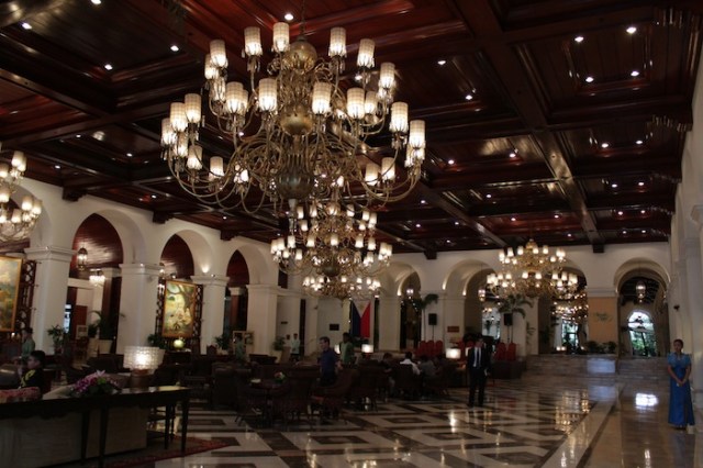 The vast, opulent lobby of the Manila Hotel.