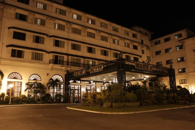 The glamorous entryway to the hotel, at night.