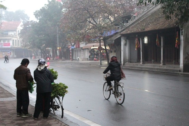 Selling her wares in the foreground of an ancient Confucian temple.