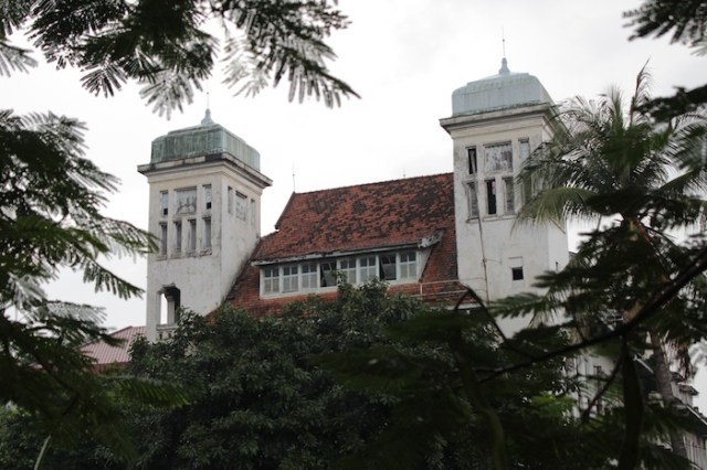 Another imposing twin-turreted merchant building, dilapidated.   