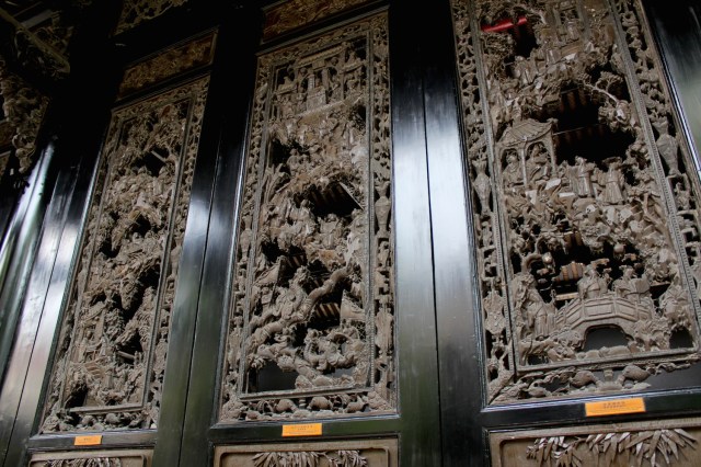 Ornate wooden panelling, reminiscent of similar panelling in Southeast Asian temples.