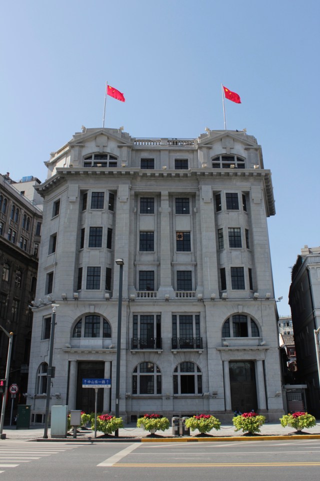 Bund #5 is the Nisshin Kisen Kaisha (Japanese Steamship Company) Building, designed by Lester Johnson & Morris in a Beaux-Arts style and erected in 1921.  It was restored and reopened in 1999 as M on the Bund. 