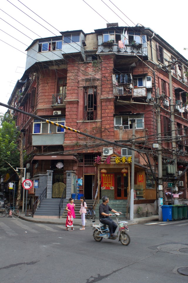Neighbours gossiping in front of a building in the Russian Concession.
