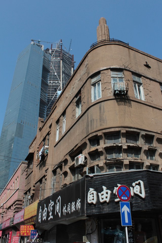 Small businesses, juxtaposed against towering skyscrapers.