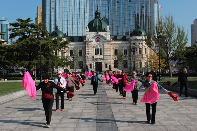 Chinese seniors dancing in what was Nicholas Square.  the building was built in 1910 during the Japanese era and housed the Daqing Bank.  