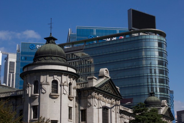 The Bank of Korea building, built by the Japanese in the Keijo era, juxtaposed against Seoul's modern skyline.  