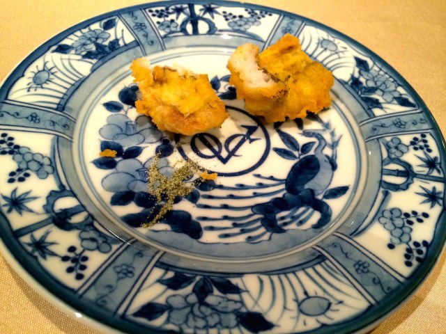 Fried pieces of fish served upon a mock- V.O.C. plate. 